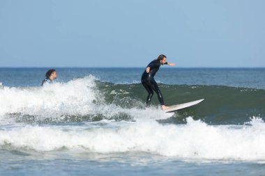 Deal, New Jersey - 10 Ağustos 2024: sörfçüler Debby Kasırgası 'nın kalıntılarında Deal açıklarında sörf yapıyor.