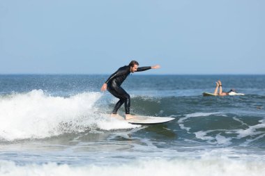 Deal, New Jersey - 10 Ağustos 2024: sörfçüler Debby Kasırgası 'nın kalıntılarında Deal açıklarında sörf yapıyor.