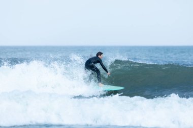 Deal, New Jersey - 10 Ağustos 2024: sörfçüler Debby Kasırgası 'nın kalıntılarında Deal açıklarında sörf yapıyor.