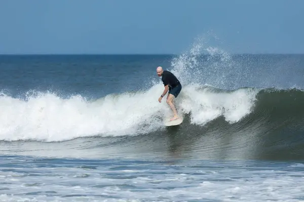 stock image Deal, New Jersey - August 10, 2024: surfers surf the remnants of Hurricane Debby in the waters off Deal