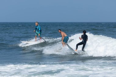 Deal, New Jersey - 18 Ağustos 2024: Sörfçüler Ernesto Kasırgası 'nın kalıntılarında sörf yapmak için Deal' da suyu dolduruyorlar