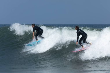 Deal, New Jersey - 18 Ağustos 2024: Sörfçüler Ernesto Kasırgası 'nın kalıntılarında sörf yapmak için Deal' da suyu dolduruyorlar