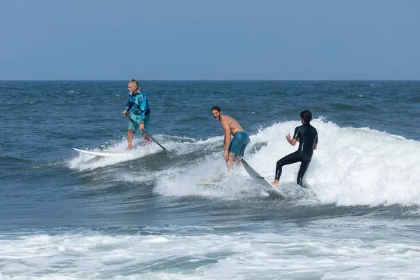 stock image Deal, New Jersey - August 18, 2024: Surfers crowd the water in Deal to surf the remnants of Hurricane Ernesto