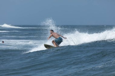 Deal, New Jersey - 18 Ağustos 2024: Sörfçüler Ernesto Kasırgası 'nın kalıntılarında sörf yapmak için Deal' da suyu dolduruyorlar