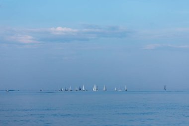 Sailboats race across the Raritan Bay in the area between Staten Island and New Jersey on August 14, 2024. clipart