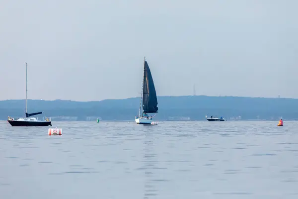 stock image Keyport, New Jersey - August 14, 2024: A sailboat travels Raritan Bay near the Keyport Yacht Club