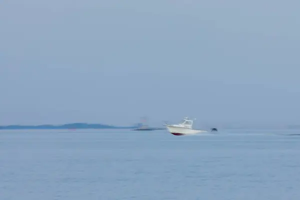 stock image A motor boat travels across the Raritan Bay. A long exposure was used to capture motion.