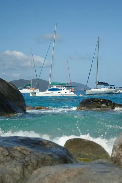 stock image Virgin Gorda, British Virgin Islands - February 27, 2006: A view of the beautiful boulders and rock formations in the Baths. Sailboats are anchored in the background.