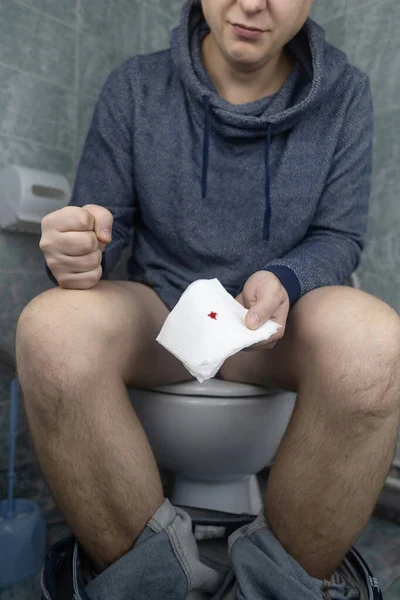 Hemorrhoid Concept Man Sits Toilet Holds White Toilet Paper His — Stock Photo, Image