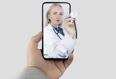 Concept. A girl in a white coat conducts a consultation. The doctor hand with a stethoscope protrudes from the screen. Remote examination, online medical care, training of doctors, advanced training. clipart