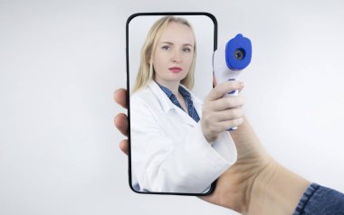 Kavram. Beyaz önlüklü bir kız danışmanlık yapıyor. Ekrandaki steteskop çıkıntılı doktor eli. Uzaktan muayene, çevrimiçi tıbbi bakım, doktorluk eğitimi, ileri eğitim..