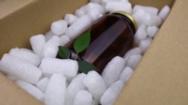 Eco package of parcels and biodegradable filler. Box is filled with a filler that does not harm the environment. Delivery of goods, parcels, delivery service, nature protection.  Recycling