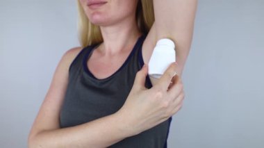 Girl holds in her hands three eco-friendly antiperspirants with natural ingredients. Refusal of antiperspirants containing toxic substances. Freedom from Aluminum chlorohydrate, alcohol, parabens