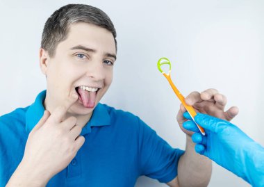 Tongue scraper. Man shows yellow plaque and then performs oral hygiene. Cleaning the tongue with special tool. Doctor recommendations and dentist advice. Before and after. Removing unpleasant odor clipart