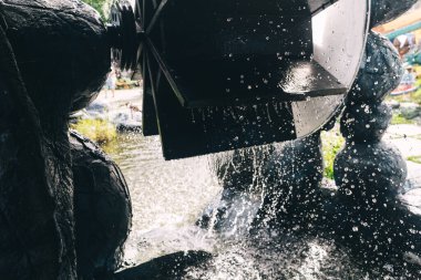 Parktaki su çarkı. Su enerjisini enerjiye dönüştüren dönen bir mekanizma. Hidroelektrik ve kinetik jeneratör.