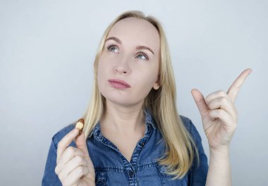 Prevention of thyroid diseases. Woman holds brazil nuts, rich in selenium, good for the thyroid gland clipart