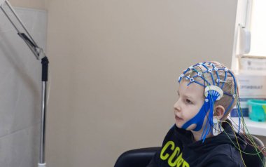 Bir çocuğun beyni EEG makinesinde incelenir. Elektroensefalogram nörolojik hastalıkların tespiti için bir hastane laboratuvarında yapılır. Çocuklar için ensefalogram