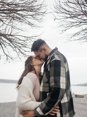 Yürüyüşe çıkmış şık elbiseli genç bir çift. Romantik bir buluşma. Yürü, öpücükler ve sarılmalar