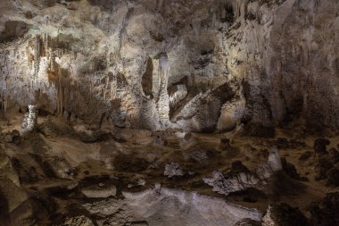 Carlsbad Caverns are located within the Carlsbad Caverns National Park in southeastern New Mexico. The caverns formed when sulfuric acid dissolved the limestone deposits about four to six million years ago. clipart