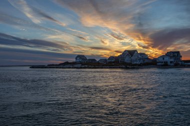 East Matunuck Jetty and Jerusalem on Hazard Island in Narragansett, Rhode Island at sunset clipart