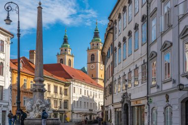 LJUBJANA, SLOVENIA - NOVEMBER 05.2022: Slovakya 'nın başkentindeki mimari binalarla sokak manzarası, Katedral Kulesi' nin arka planı