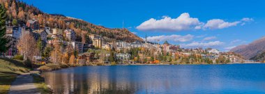 Panorama view over the St. Moritz lake in St. Moritz in autumn colours in Engadine, background the mountains clipart
