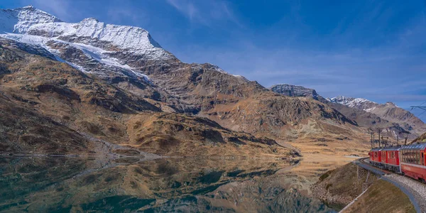 stock image Lake Bianco at the Bernina Express of Rhaetian railway line on a autumn day, background beautiful mountain