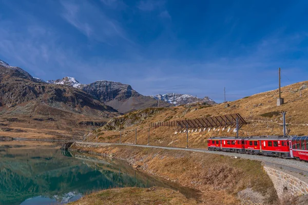 Stock image OSPIZIO BERNINA, SWITZERLAND - OCTOBER 28,2022: Lake Bianco at the Bernina Express of Rhaetian railway line on a autumn day, background beautiful mountain