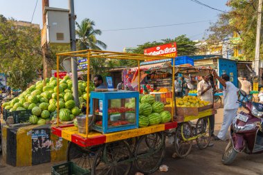 Puttaparthi, Andra Pradesh - India - January 21.2023: A man selling watermelon on the local Indian vegetable market in Puttaparthi