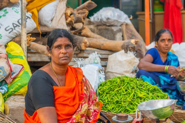 Puttaparthi, Andra Pradesh - India - January 21.2023: A women selling vegetables on the local Indian market in Puttaparthi