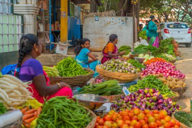 Puttaparthi, Andra Pradesh - India - January 21.2023: Womens on the local Indian vegetable market, selected focus