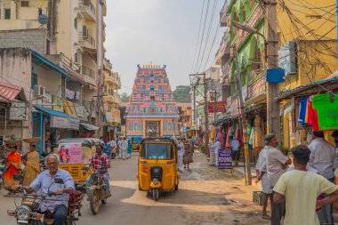 Puttaparthi, Andra Pradesh - India - January 21.2023: A street at Puttaparty, in background the entrance to the Sai Baba ashram