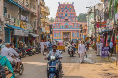 Puttaparthi, Andra Pradesh - India - January 21.2023: A street at Puttaparty, in background the entrance to the Sai Baba ashram