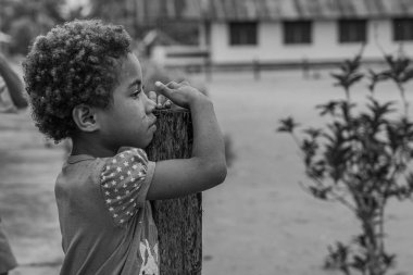 Raja Ampat, Indonesia -February 6. 2023 : Black white picture of a girl in Raja Ampat, West Papua, side view of the face