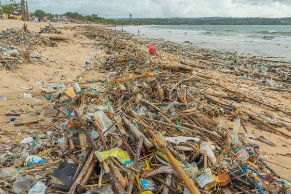 stock image Jimbaran Beach, Indonasia - February 13.2023: Jimbaran beach on Bali full of garbage at the sandy beach