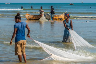 Morondava, Madagascar - May 31.2023: Two women with fishernet at the coastline from Morondava fishing