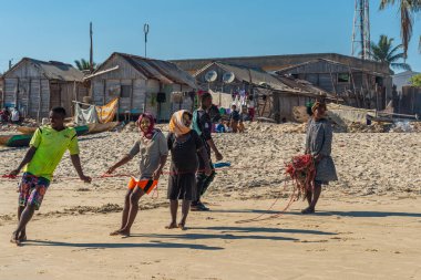Morondava, Madagascar - May 31.2023: People pull a rope to fish at the coastline from Morondava