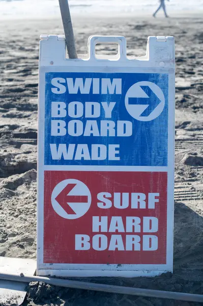 board with the directions on the beach