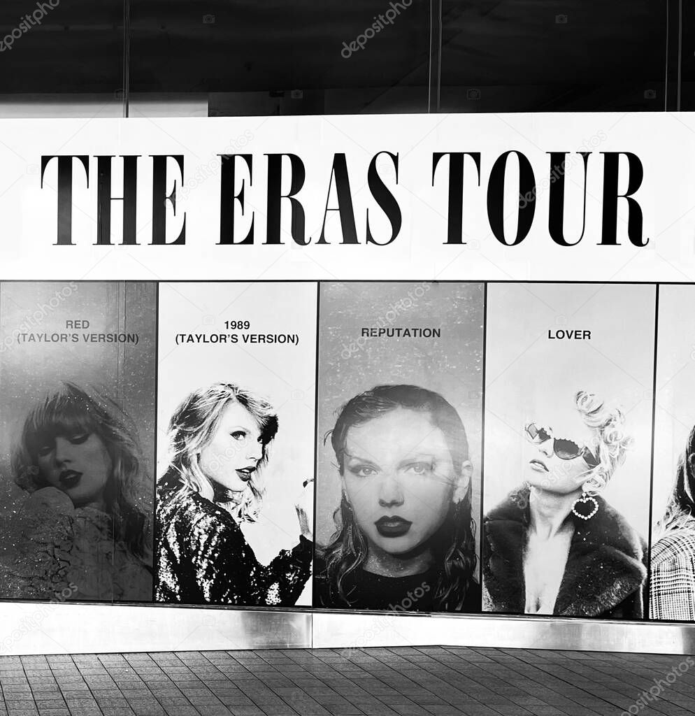 Sydney, Australia - February 13, 2024: Taylor Swift promotional banner for the Eras Tour on a building facade. A striking monochrome shot captures the drama and anticipation.