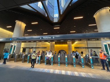 Sydney, Australia - August 24, 2024:  Passengers exiting at Sydney Metro Gadigal railway station entrance. Gadigal station provides enhanced metro connectivity to the central retail precinct in the Sydney CBD. clipart