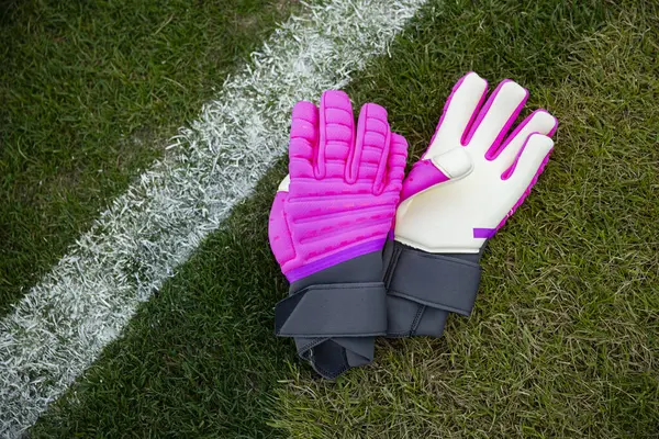 明るいピンクのサッカーのゴールグローブやサッカーのキーパーの手袋の近くのビュー すべてのゴールキーパーは良い手袋を必要とします ストックフォト