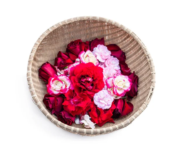 red and  pink rose petals in wicker basket isolated on white