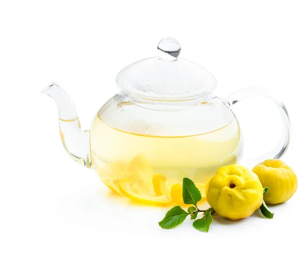 Hot quince  tea in transparent teapot with fresh fruits isolated on white