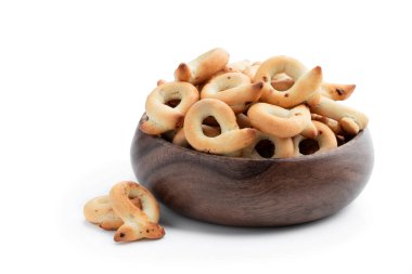 Italian  taralli with onion in wooden bolw isolated on white  clipart