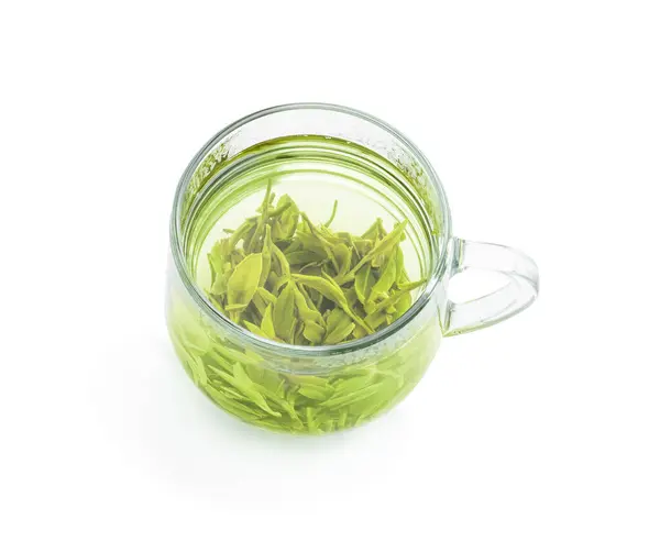 stock image Longjing  tea in glass cup isolated on white background 