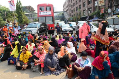 Olio Giyim işçileri, 1 Kasım 2022 'de Dhaka, Bangladeş' teki ödenmemiş maaş ve yardımlarını talep etmek için bir yolu kapattılar..