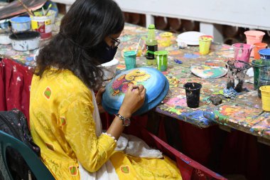 Dhaka Üniversitesi Güzel Sanatlar Fakültesi öğrencisi, Bangladeş 'in Dhaka şehrinde 1430 yılını kutlamak için renkli maskeler boyuyor.. 