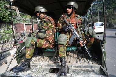 Bangladesh Army personnel sit in the back of a vehicle in Dhaka, Bangladesh, on January 3, 2024, to assist local administrations ahead of the upcoming general election on January 7. The armed forces are being deployed nationwide in preparation for th