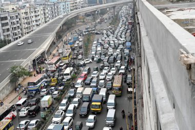 Bangladeşliler, 18 Mart 2024 'te Bangladeş' in Dhaka kentindeki kutsal Ramazan ayı boyunca trafik sıkışıklığında otururken, yoğun Dhaka 'daki trafik sıkışıklığı, işçiler evlerine gidebilsin diye ofis saatleri boyunca daha da kötüleşti.