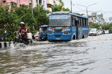 Vehicles and rickshaws are trying to drive with passengers through the waterlogged streets caused by heavy monsoon rainfalls in Dhaka, Bangladesh, on June 26, 2024.  clipart